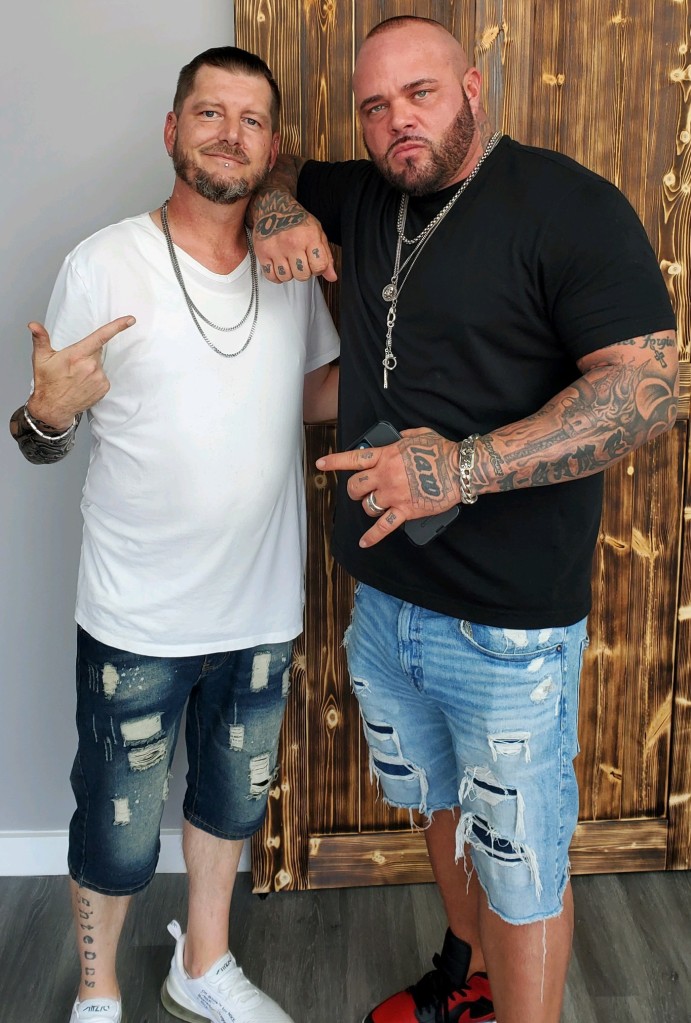 Stylz posing with Struggle Jennings just after cutting his hair.