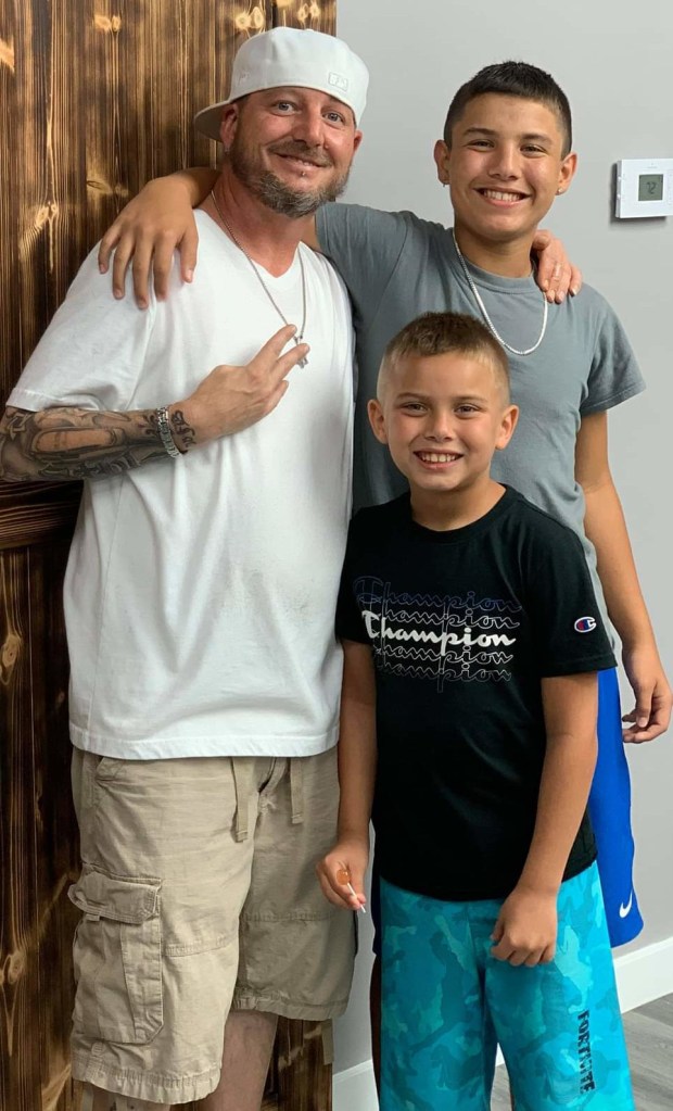 Stylz posing with two young male clients.