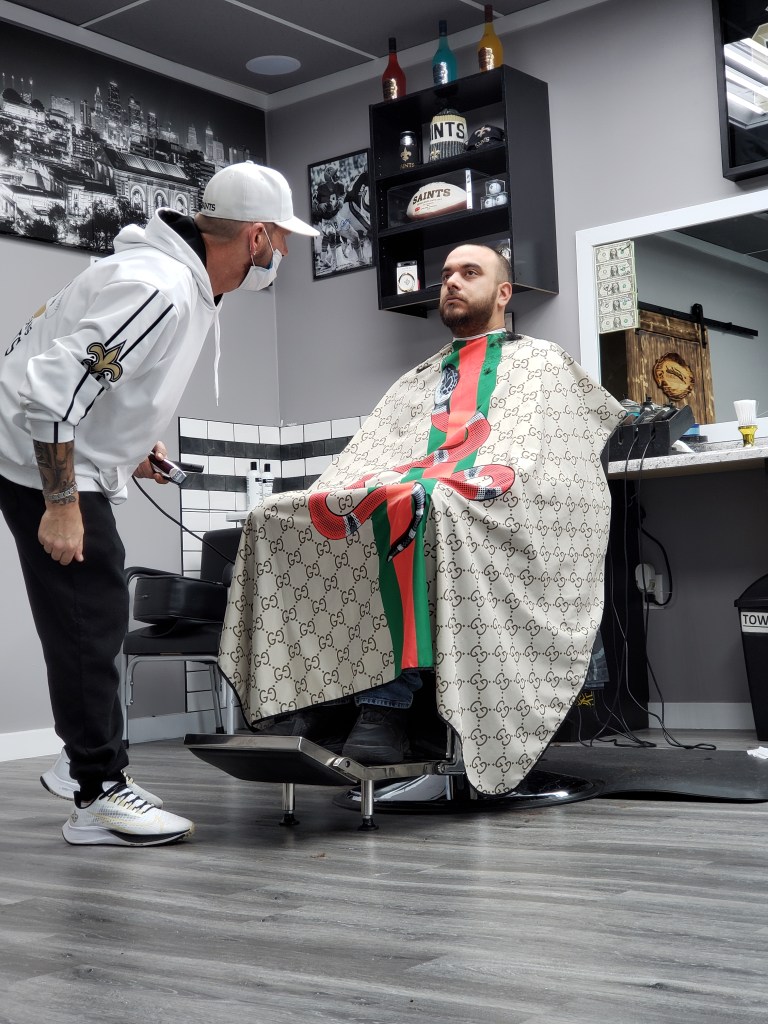 Stylz checking a client's cut.