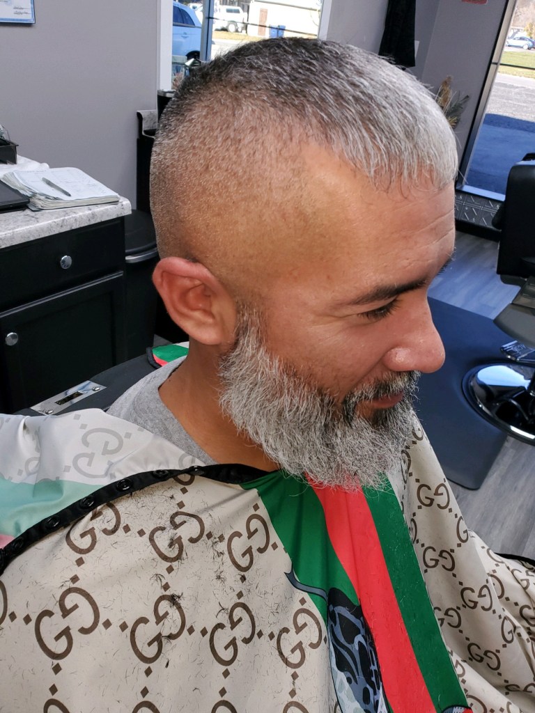A man with salt-and-pepper hair and beard.