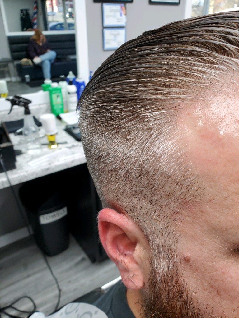 Freshly cut salt-and-pepper hair.