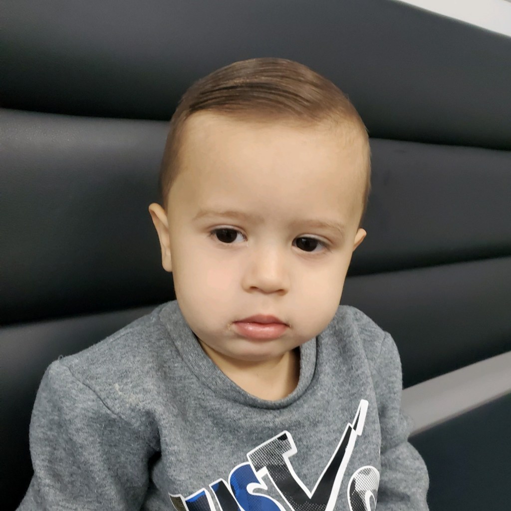 A toddler with freshly cut hair.