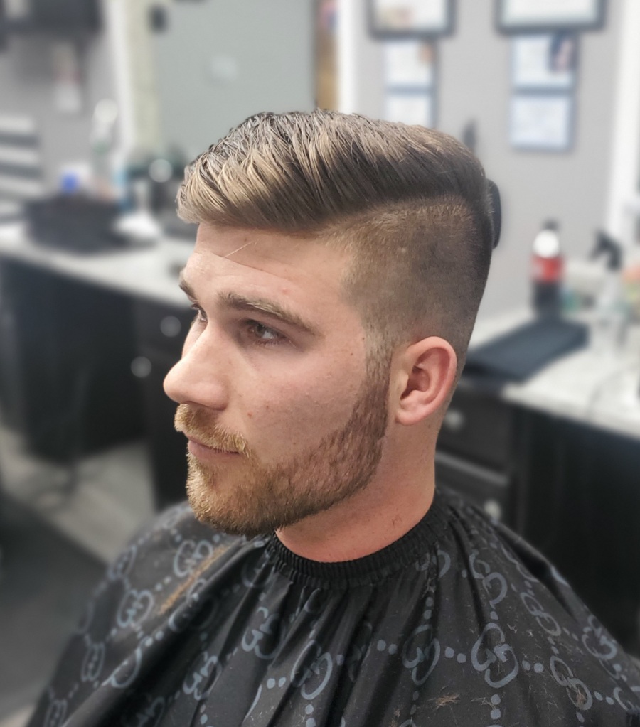 A young man with freshly cut hair and a trimmed beard.