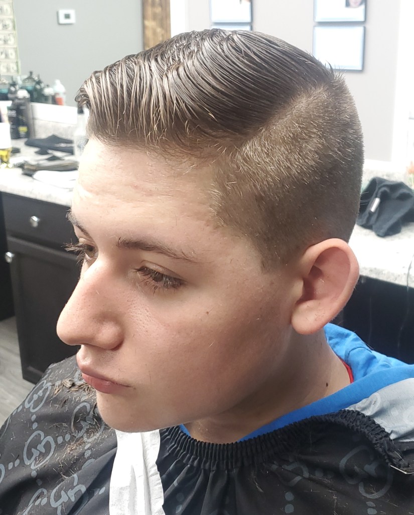 A teenage boy with freshly cut hair