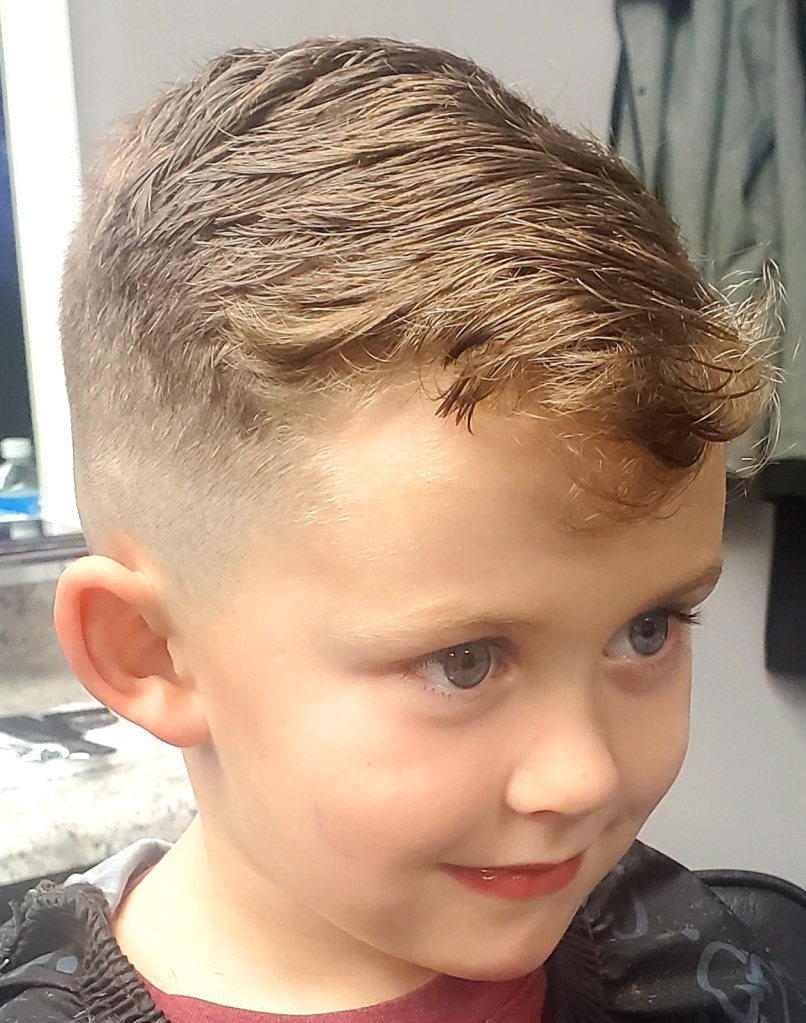 A young boy with a fresh haircut.