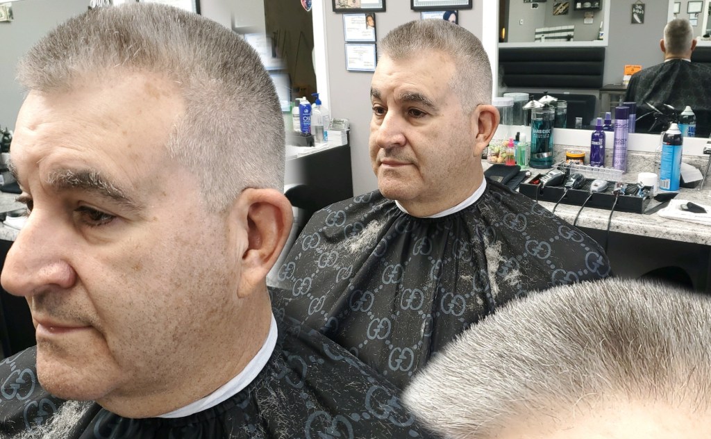 Three views of an older man's freshly cut hair.